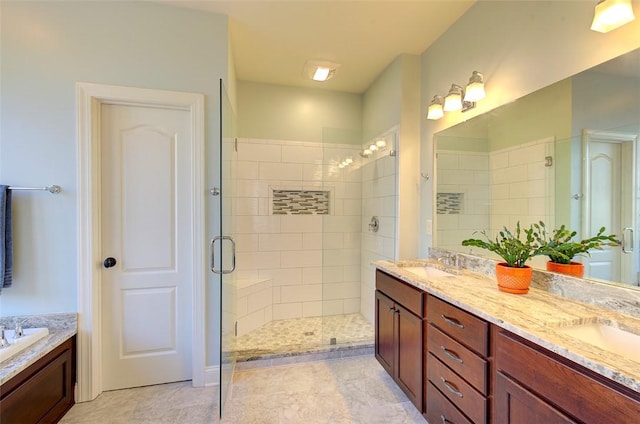 bathroom featuring vanity and shower with separate bathtub