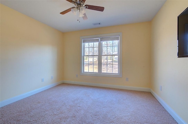 spare room with ceiling fan and carpet floors