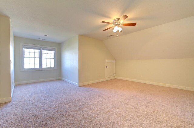 bonus room with light carpet, ceiling fan, and vaulted ceiling