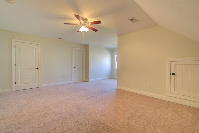 additional living space with ceiling fan, light colored carpet, and lofted ceiling