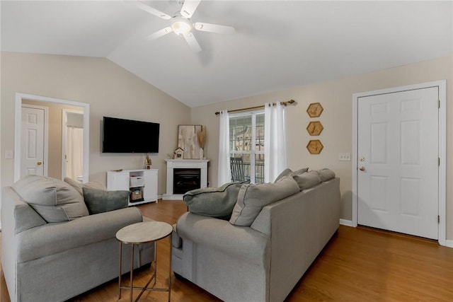 living room featuring lofted ceiling, ceiling fan, and hardwood / wood-style flooring