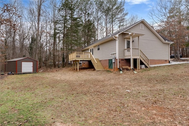 back of property with a wooden deck and a shed