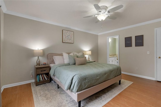 bedroom featuring ceiling fan, ensuite bath, wood-type flooring, and ornamental molding