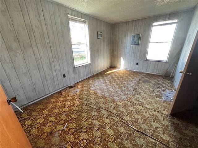 unfurnished room with a textured ceiling