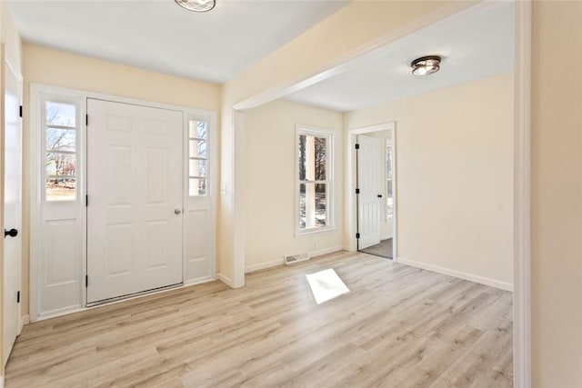 foyer entrance with light hardwood / wood-style floors