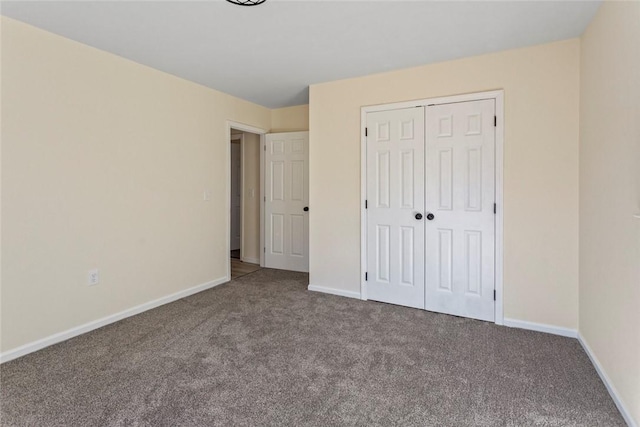 unfurnished bedroom with carpet and a closet