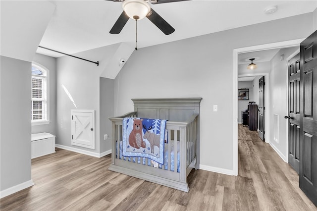 bedroom featuring lofted ceiling, light hardwood / wood-style flooring, and ceiling fan