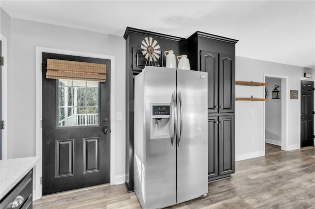 kitchen featuring stainless steel fridge, dishwasher, and light hardwood / wood-style flooring