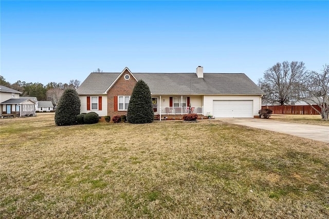 view of front of property featuring a garage, covered porch, and a front yard