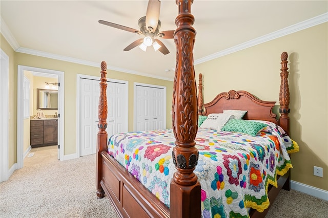 carpeted bedroom featuring ceiling fan, ornamental molding, connected bathroom, and two closets