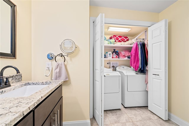 clothes washing area with sink and washing machine and dryer