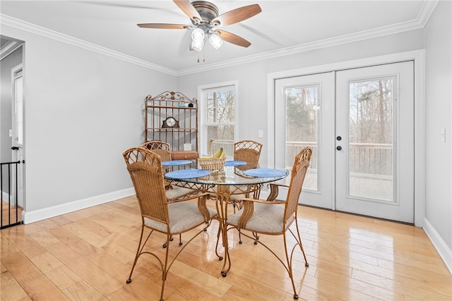 dining room featuring light hardwood / wood-style flooring, ornamental molding, french doors, and ceiling fan