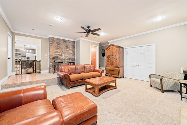 carpeted living room featuring ceiling fan, ornamental molding, and a fireplace