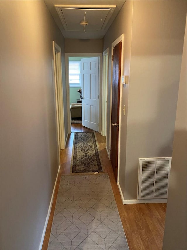 corridor with light hardwood / wood-style floors