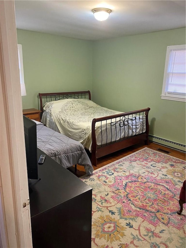 bedroom with a baseboard heating unit