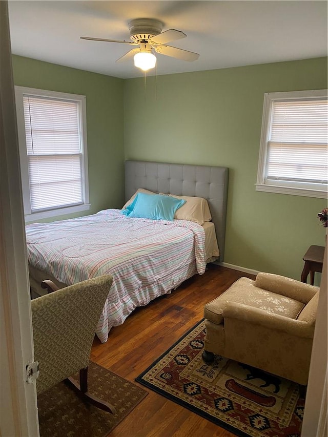 bedroom with ceiling fan and dark hardwood / wood-style floors