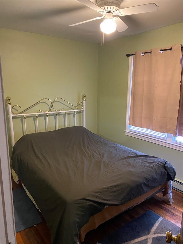 bedroom with ceiling fan and hardwood / wood-style floors