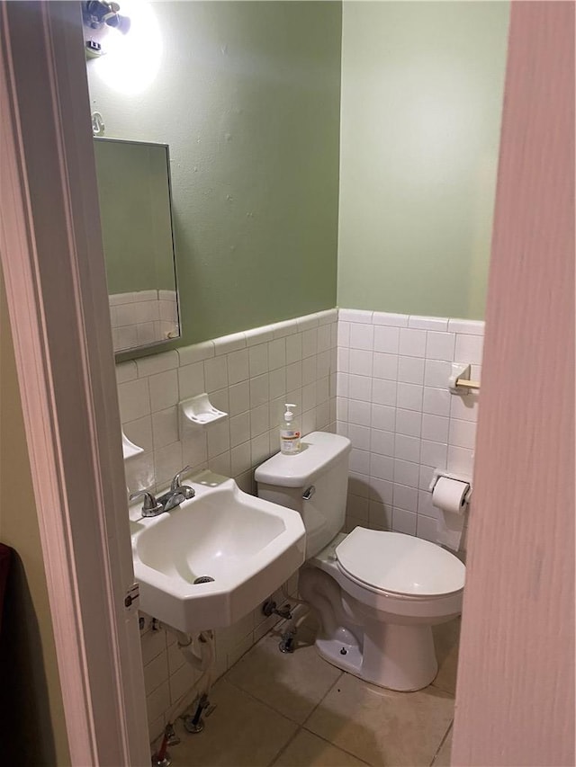 bathroom featuring sink, tile patterned floors, and toilet