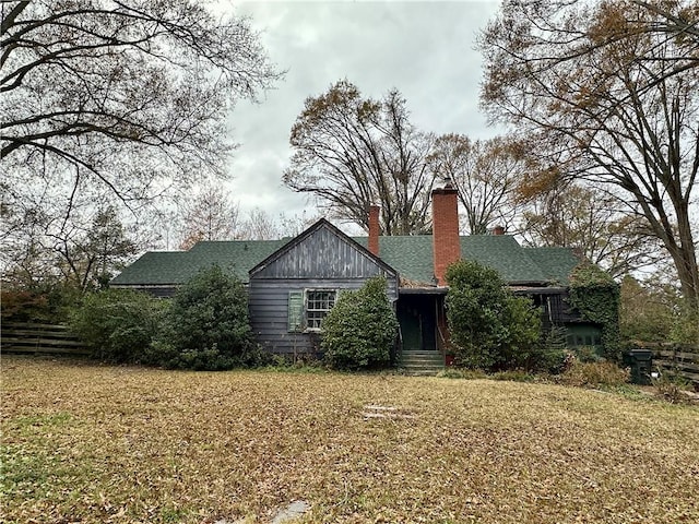 back of house with a lawn