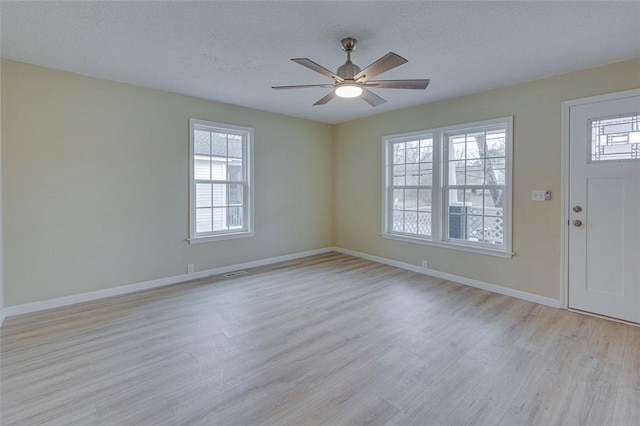 foyer with light hardwood / wood-style floors, a textured ceiling, and ceiling fan