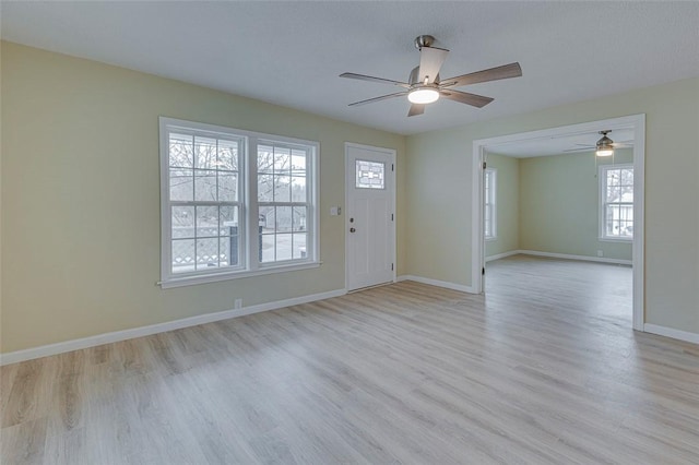 interior space with a healthy amount of sunlight, light hardwood / wood-style flooring, and ceiling fan