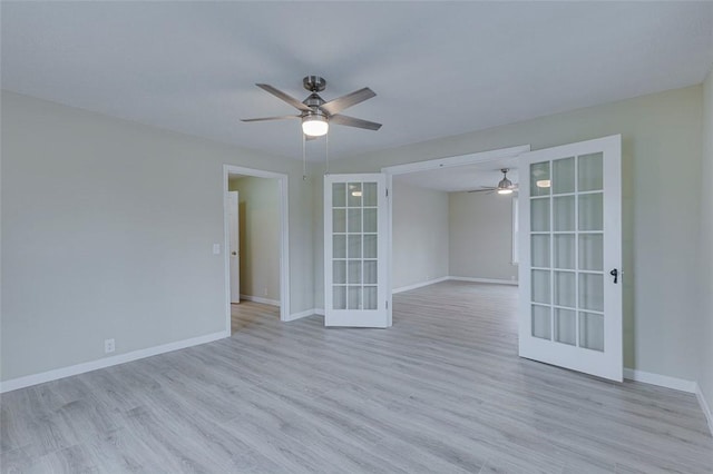 spare room featuring light hardwood / wood-style floors, ceiling fan, and french doors