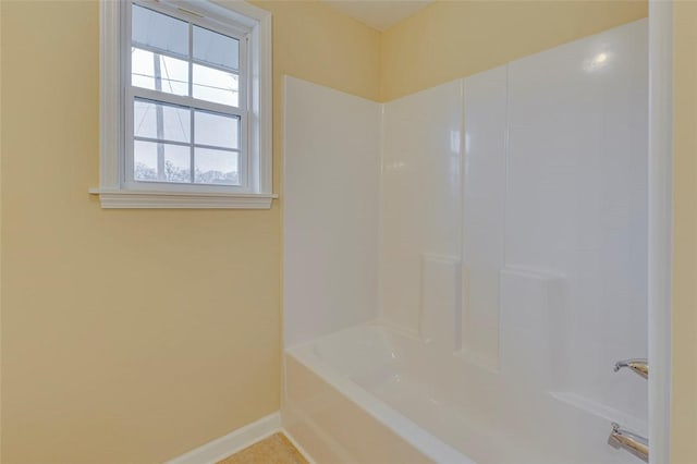 bathroom featuring shower / bathtub combination and tile patterned flooring