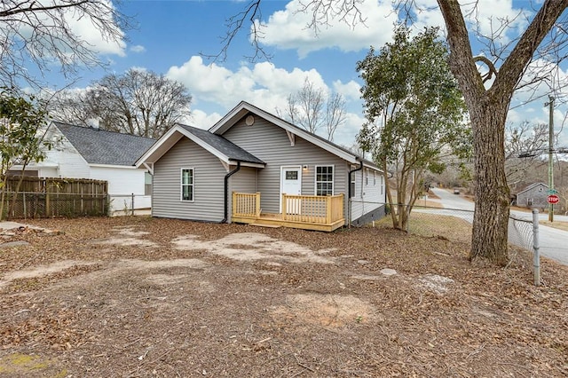 rear view of property featuring a deck