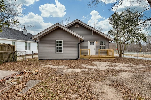 back of house featuring a wooden deck