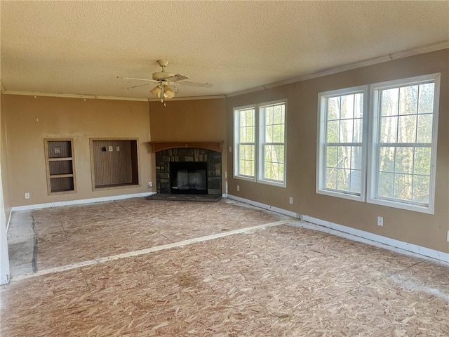 unfurnished living room with ceiling fan, a textured ceiling, crown molding, and a fireplace