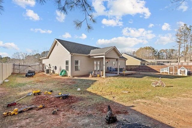 back of house with a patio and a lawn