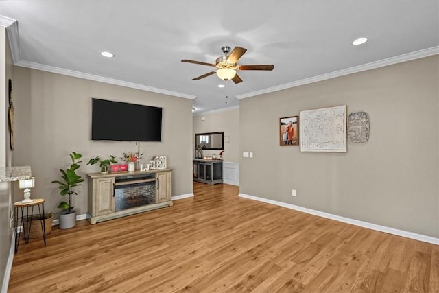 living room featuring light wood-type flooring, ceiling fan, and ornamental molding