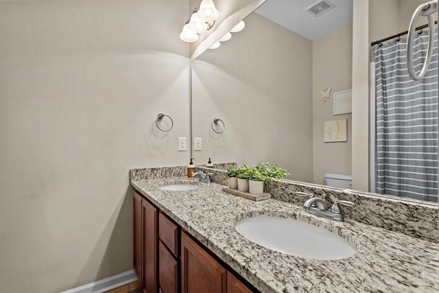 bathroom with toilet and vanity