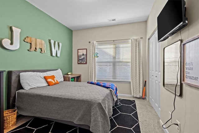 carpeted bedroom with a closet