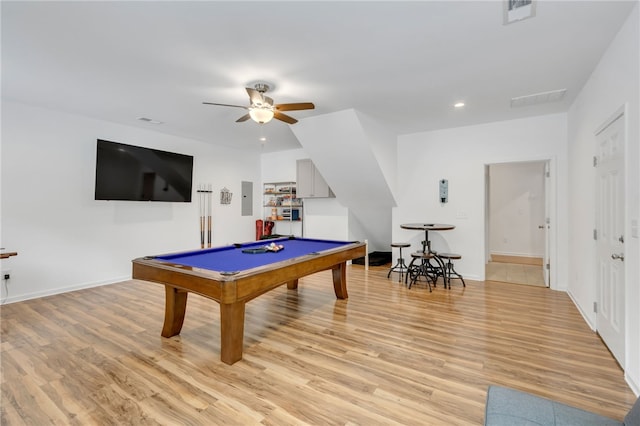 game room with billiards, light hardwood / wood-style flooring, ceiling fan, and electric panel