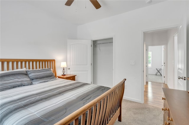 carpeted bedroom featuring a closet and ceiling fan