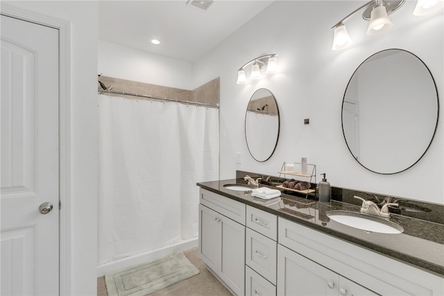 bathroom featuring a shower with curtain, tile patterned floors, and vanity