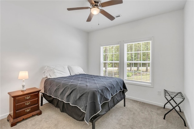 bedroom with light carpet and ceiling fan