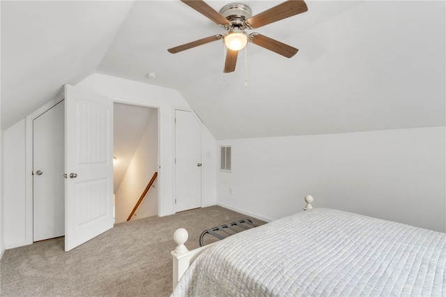 carpeted bedroom with vaulted ceiling and ceiling fan