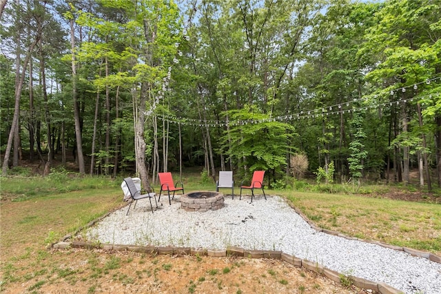 view of yard with an outdoor fire pit