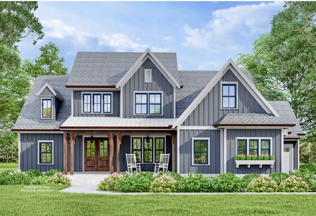 rear view of house featuring a lawn and french doors