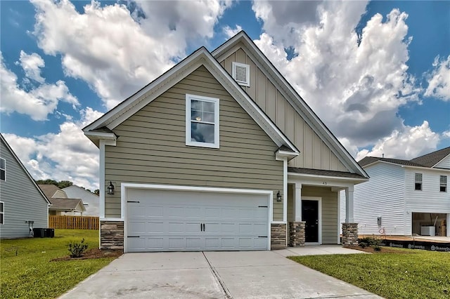 craftsman-style home with a garage, a front lawn, and central AC unit