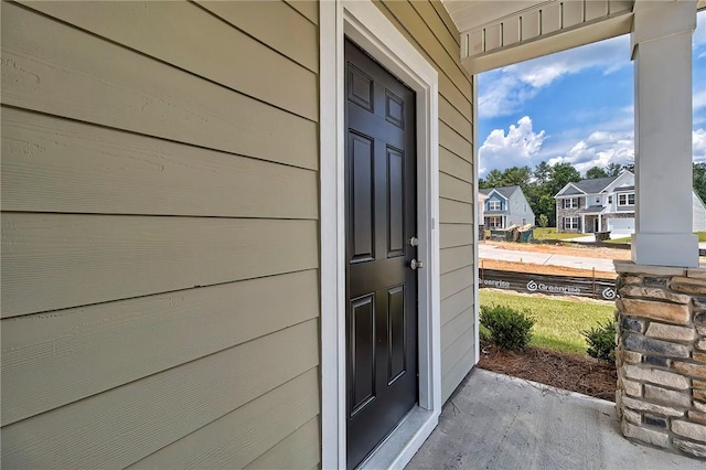 view of exterior entry featuring a porch