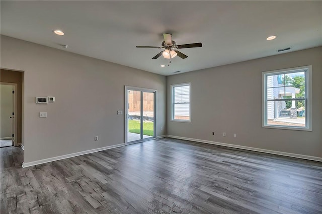 unfurnished room featuring hardwood / wood-style floors, plenty of natural light, and ceiling fan