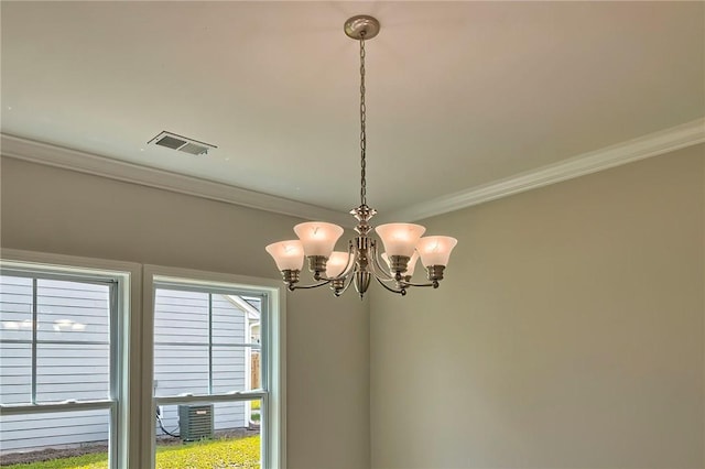 details featuring ornamental molding and a notable chandelier