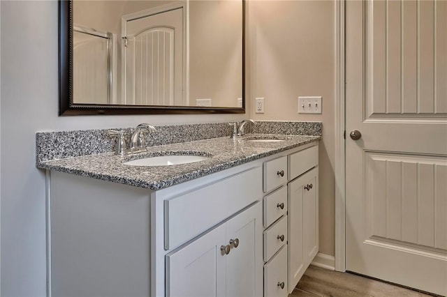 bathroom featuring vanity and hardwood / wood-style floors