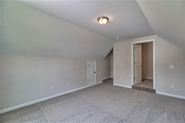 bonus room featuring vaulted ceiling and carpet floors