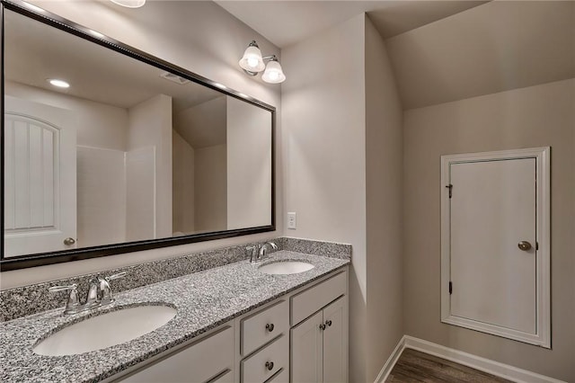 bathroom featuring hardwood / wood-style flooring and vanity