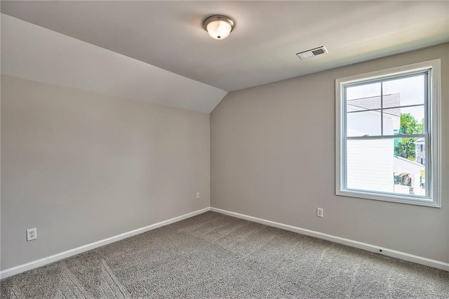 bonus room with vaulted ceiling and carpet