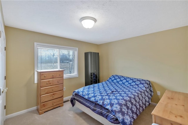 carpeted bedroom with a textured ceiling